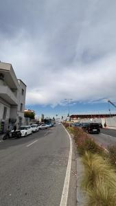 a street with cars parked on the side of the road at Civico77AirPort in Naples