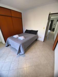 a bedroom with a bed with towels on it at Patagonico in Puerto Madryn
