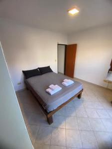a bedroom with a bed with two towels on it at Patagonico in Puerto Madryn