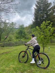 a person riding a bike in the grass at Hostel Mojan in Andrijevica