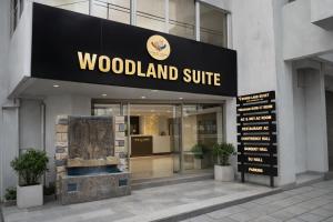 a woodland shuttle sign in front of a building at WoodLand Suites in Cochin
