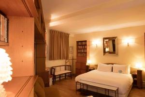 a hotel room with a bed and a mirror at Hôtel Grand Amour in Paris