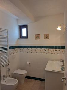 a bathroom with a toilet and a sink at Il Grottino di Sarzana in Sarzana +20 photos
