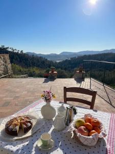 a table with a plate of fruit on it at Il Grottino di Sarzana in Sarzana