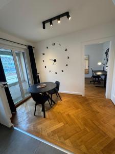 a room with a table and a clock on the wall at Cosy studio in Lausanne Flon in Lausanne