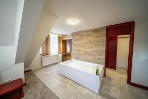 a large bathroom with a tub in the middle at Divski Resort in Divčibare