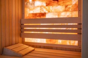 a bench in a sauna with a window at Divski Resort in Divčibare