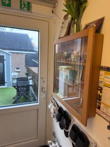 a kitchen with a cupboard and a window at Guesthouse Czaar Peter in Zaandam +26 photos