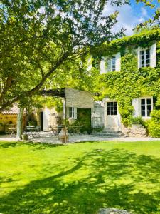 a large green building with a grass yard at Domaine La Parpaille in Cucuron