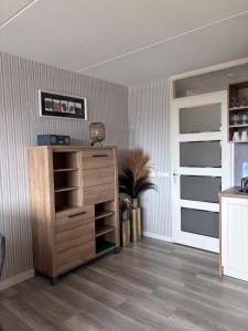 a room with a wooden dresser in a room at Amelander Paradijs Ferienwohnung in Buren +25 photos