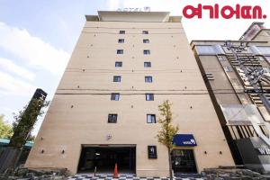 a tall building with a sign on the side of it at 월호텔 in Cheonan