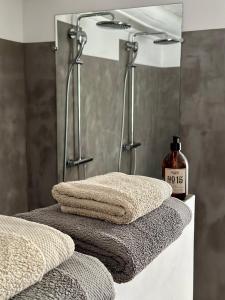 a bathroom with three towels and a bottle of soap at Domaine La Parpaille in Cucuron +47 photos