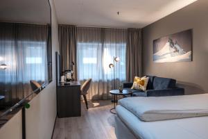 a hotel room with a bed and a desk at Thon Hotel Baronen in Ålesund +23 photos