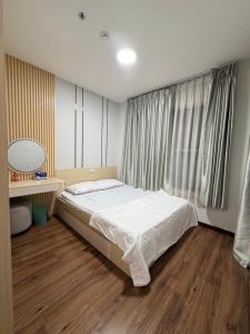 a bedroom with a bed and a large window at Youyi House in Dĩ An +5 photos