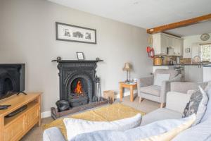 a living room with a fire place in the middle at Tanderra Coniston in Coniston