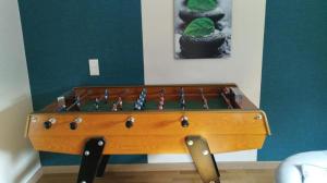 a wooden snooker table in a room at Nuit etoile et jacuzzi prive in Pleuven +1 photo