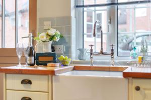 a kitchen with a sink and a window at Channel Cottage in Wells next the Sea +12 photos