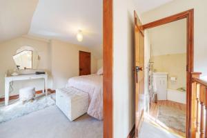 a bedroom with a bed and a mirror at Channel Cottage in Wells next the Sea