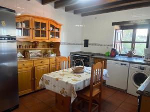 a kitchen with a table with a table cloth on it at Casa Rural La Xana in Piloña
