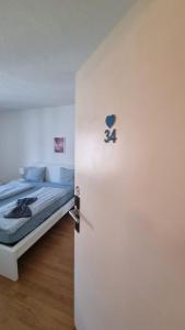 a bedroom with a bed and a door with the number on it at Zimmer In Luzern in Arni Alp +4 photos