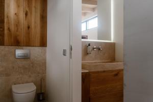 a bathroom with a toilet and a sink at Piatti beach suites in Zandvoort