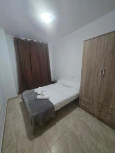 a bedroom with a bed and a wooden cabinet at Las Jarcias 2C in Moncófar