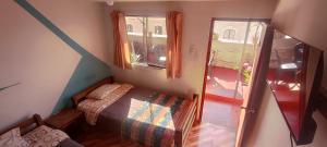 a small bedroom with a bed and a window at Peter's Hostel in Arequipa +29 photos