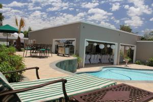 a house with a swimming pool and a patio at Firwood Lodge in Pretoria +26 photos