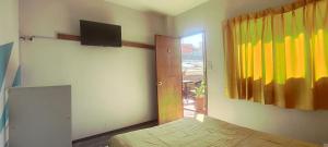 a bedroom with a bed and a television on the wall at Peter's Hostel in Arequipa
