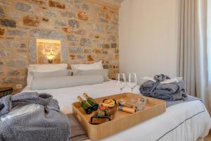 a hotel room with a bed with a tray of food at Lakkos Villas in Kardamyli +72 photos