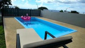 a swimming pool with a pink inflatable pool toy at Entire villa with private pool and seaview Albion Mauritius in Albion