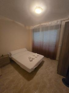 a bedroom with a bed with two towels on it at Las Jarcias 3A in Moncófar