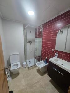 a bathroom with a toilet and a shower and a sink at Las Jarcias 3A in Moncófar +8 photos
