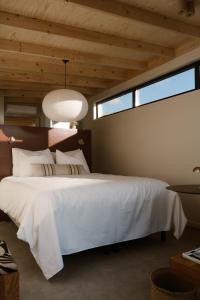 a bedroom with a large white bed and a window at Piatti beach suites in Zandvoort +20 photos