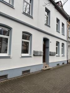 a white building with windows and a door at Ferienwohnung Florion 2 in Bernburg