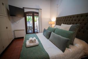 a bedroom with a large bed with two towels on it at Casona Don Roque in Salta +73 photos