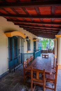 a wooden table and chairs on a patio at Casona Don Roque in Salta