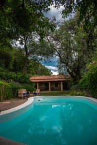a swimming pool in front of a house at Casona Don Roque in Salta