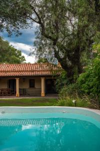 a house and a swimming pool in front of a house at Casona Don Roque in Salta