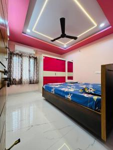 a bedroom with a bed and a ceiling at Vizag Urban Nest in Visakhapatnam