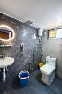 a bathroom with a toilet and a sink at Vizag Urban Nest in Visakhapatnam
