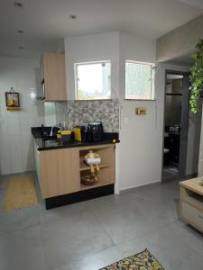 a kitchen with a sink and a counter top at Apartamento Completo localizado no centro in Matias Barbosa