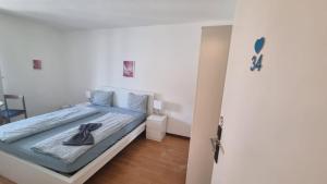 a bedroom with a bed with a blue comforter at Zimmer In Luzern in Arni Alp