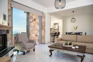 a living room with a couch and a table at Villa Alexia - Private Pool & Panoramic Sea Views in Órmos Koumaíïkon