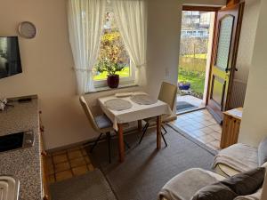 a table and chairs in a room with a window at Ferienwohnungen Gmeiner in Bad Endorf