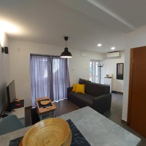 a living room with a couch and a table at Hidden place in pure center in Novi Sad