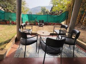 a group of chairs and tables on a patio at Perth villa in Mount Ābu +20 photos