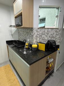 a kitchen with a sink and a counter top at Apartamento Completo localizado no centro in Matias Barbosa