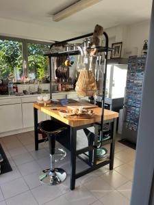 a kitchen with a table and a shelf with utensils at Casa Leopardo in Hasselt