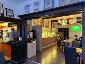 a restaurant with a table and chairs and a bar at Eifelerhof hotel Monschau in Monschau